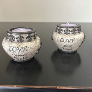 2 tea light candle holders with the words “ Love Never Fails”